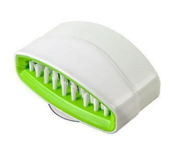 Animal-shaped kitchen cleaning tool demonstrating powerful scrubbing action with ergonomic alligator design