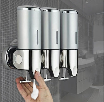 Modern wall-mounted liquid soap dispenser installed in luxury hotel bathroom with sleek chrome finish